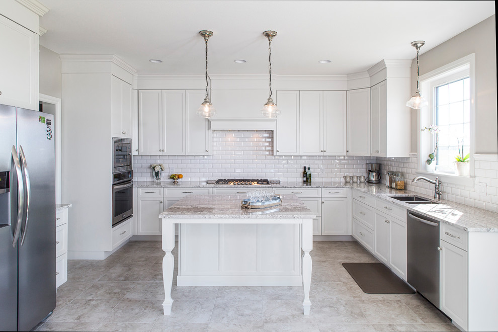 Example of a mid-sized transitional u-shaped gray floor enclosed kitchen design with a double-bowl sink, shaker cabinets, white cabinets, white backsplash, subway tile backsplash, stainless steel appliances and an island