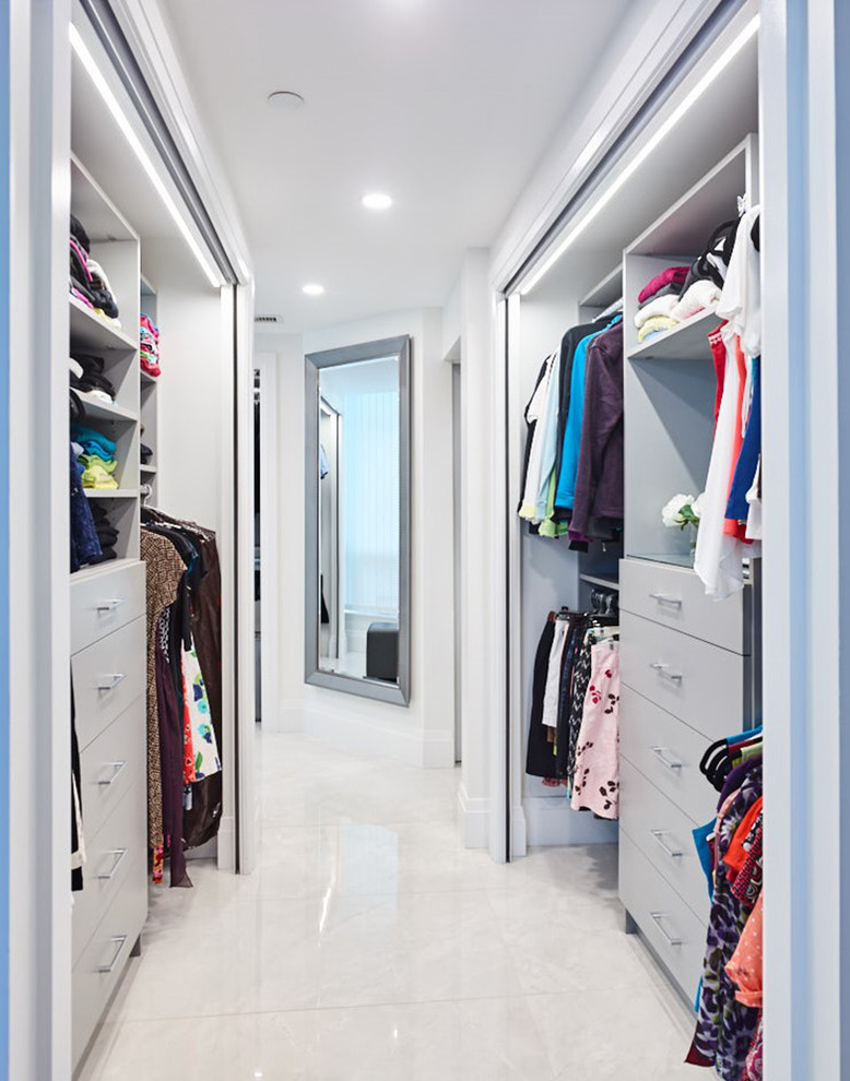 Photo of a mid-sized contemporary gender-neutral walk-in wardrobe in Other with shaker cabinets, grey cabinets and white floor.