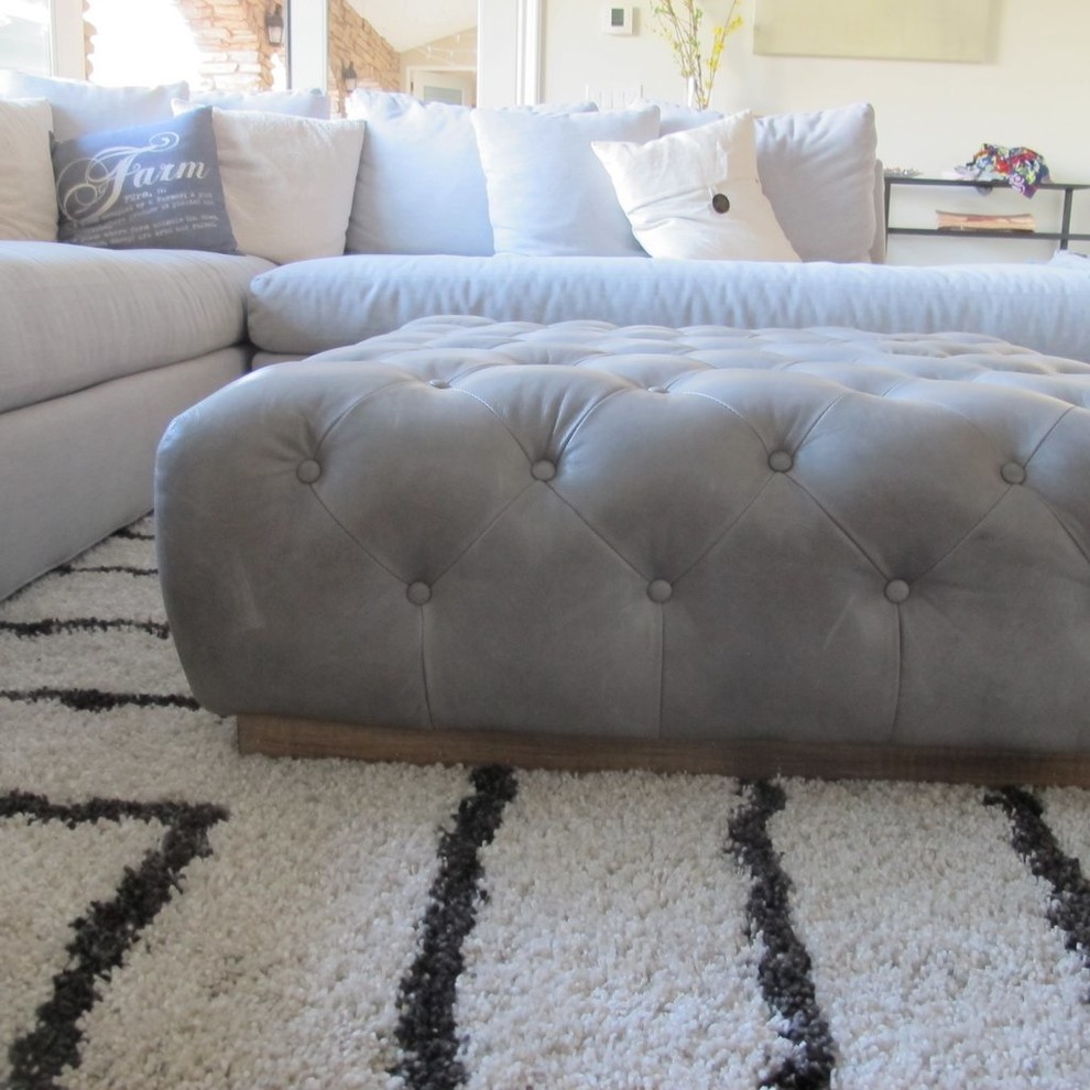 Transitional leather square and solid color tufted living room photo