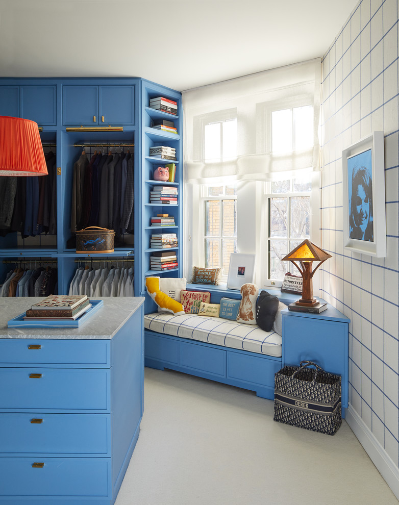 Photo of a contemporary men's dressing room in New York with carpet, blue cabinets and grey floor.