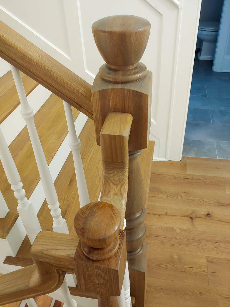 Design ideas for a mid-sized traditional wood u-shaped staircase in DC Metro with painted wood risers, wood railing and decorative wall panelling.