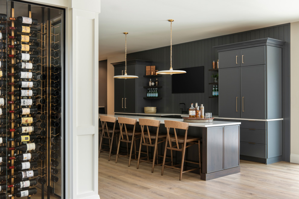 Wet bar - large transitional galley vinyl floor and brown floor wet bar idea in St Louis with an undermount sink, flat-panel cabinets, quartz countertops, gray backsplash, shiplap backsplash and white countertops