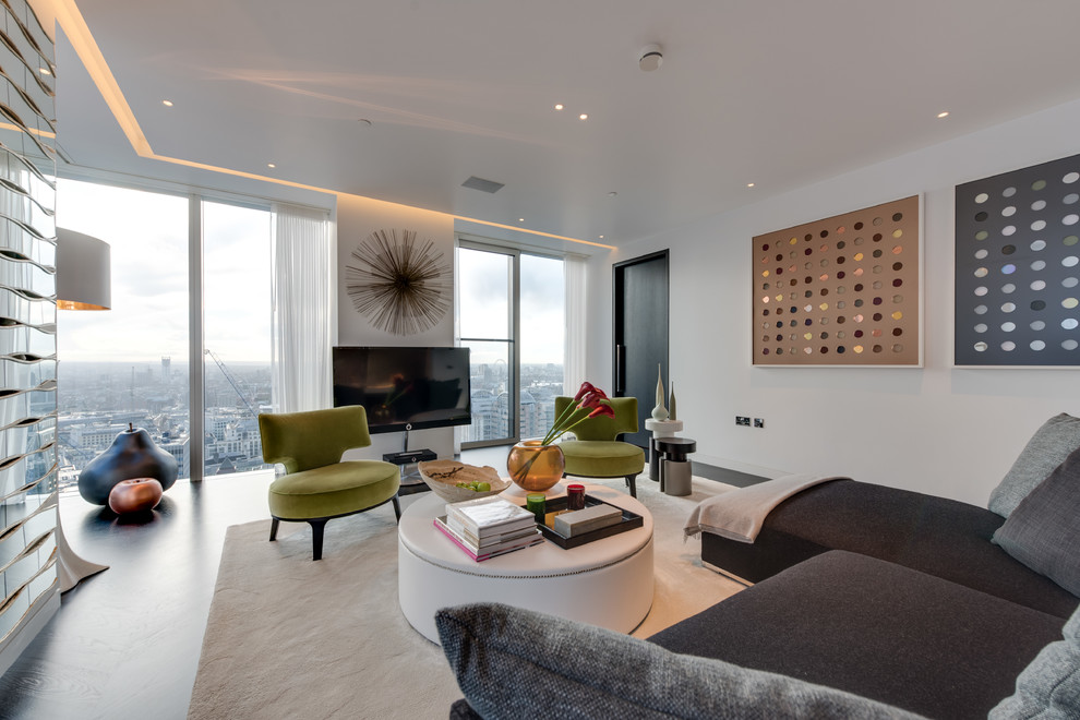 Photo of a contemporary living room in London with white walls and a wall-mounted tv.