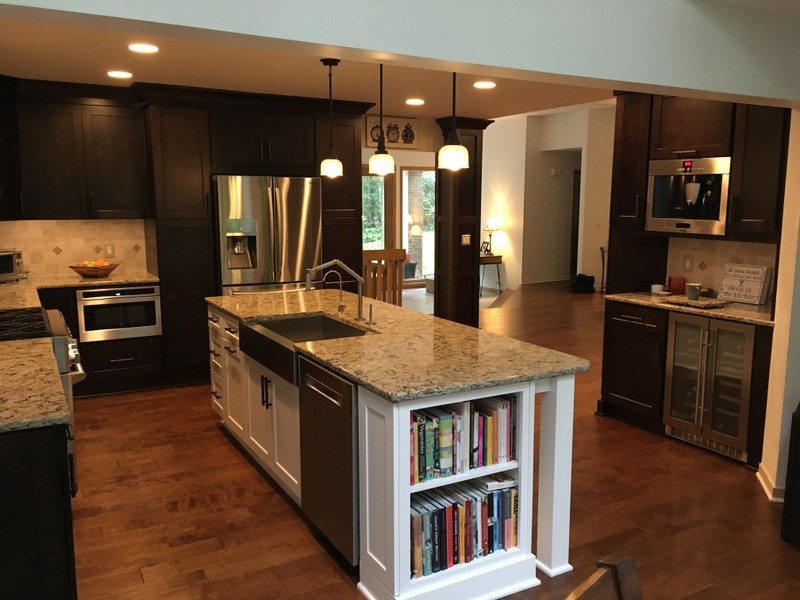 Large transitional u-shaped porcelain tile open concept kitchen photo in Detroit with a farmhouse sink, shaker cabinets, white cabinets, quartz countertops, beige backsplash, stone tile backsplash, stainless steel appliances and an island