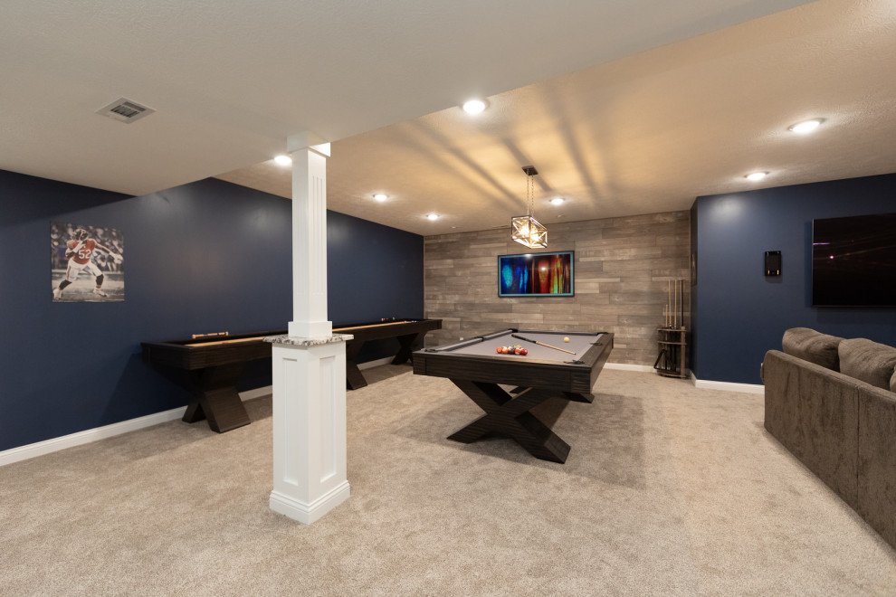 Large contemporary look-out basement in Other with blue walls, carpet, a standard fireplace, a tile fireplace surround and beige floor.