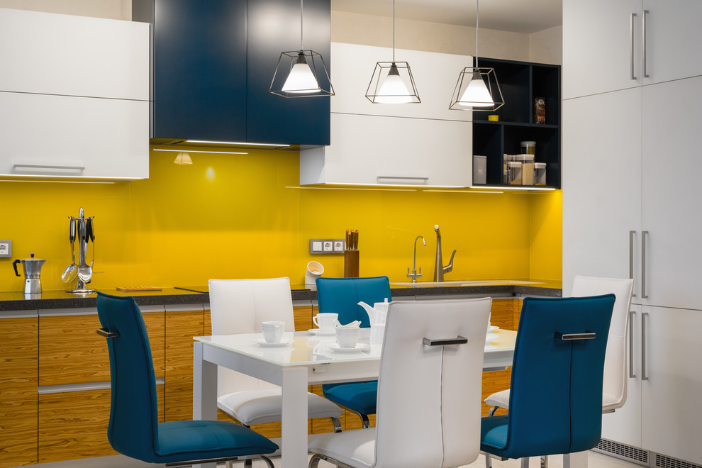 Design ideas for a contemporary l-shaped kitchen in Other with flat-panel cabinets and yellow splashback.