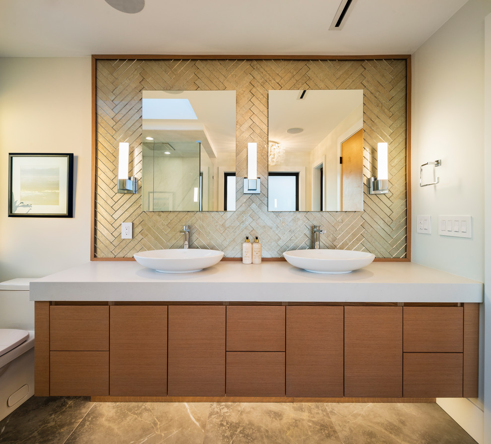 Design ideas for a large contemporary master bathroom in Vancouver with flat-panel cabinets, medium wood cabinets, a freestanding tub, a corner shower, a one-piece toilet, white tile, ceramic tile, white walls, porcelain floors, an undermount sink, engineered quartz benchtops, grey floor, a hinged shower door and white benchtops.
