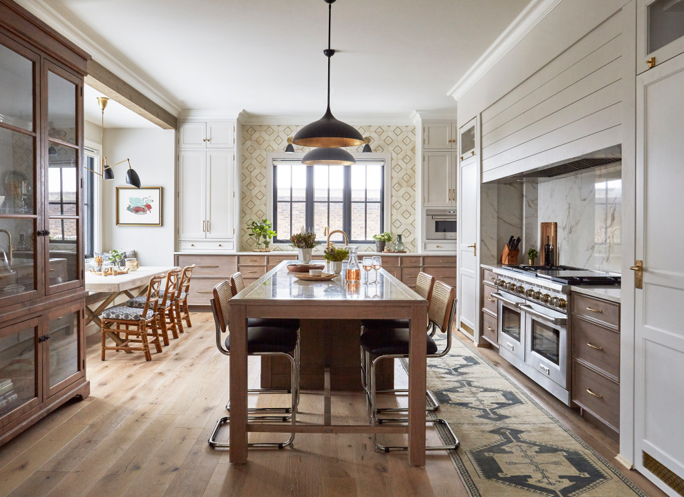 Example of an eclectic light wood floor and brown floor eat-in kitchen design in Chicago with recessed-panel cabinets, white cabinets, quartzite countertops, white backsplash, stainless steel appliances, an island and yellow countertops