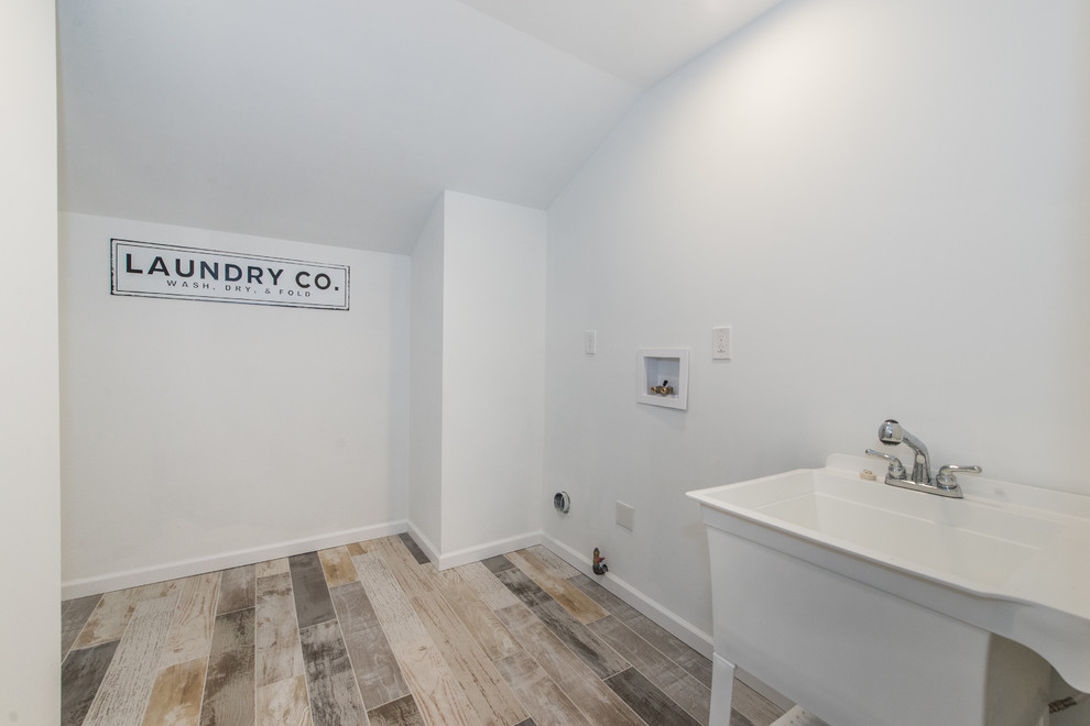 Photo of a mid-sized traditional single-wall dedicated laundry room in New York.