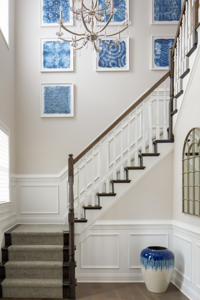 Mid-sized elegant wooden u-shaped wood railing and wainscoting staircase photo in Newark with wooden risers