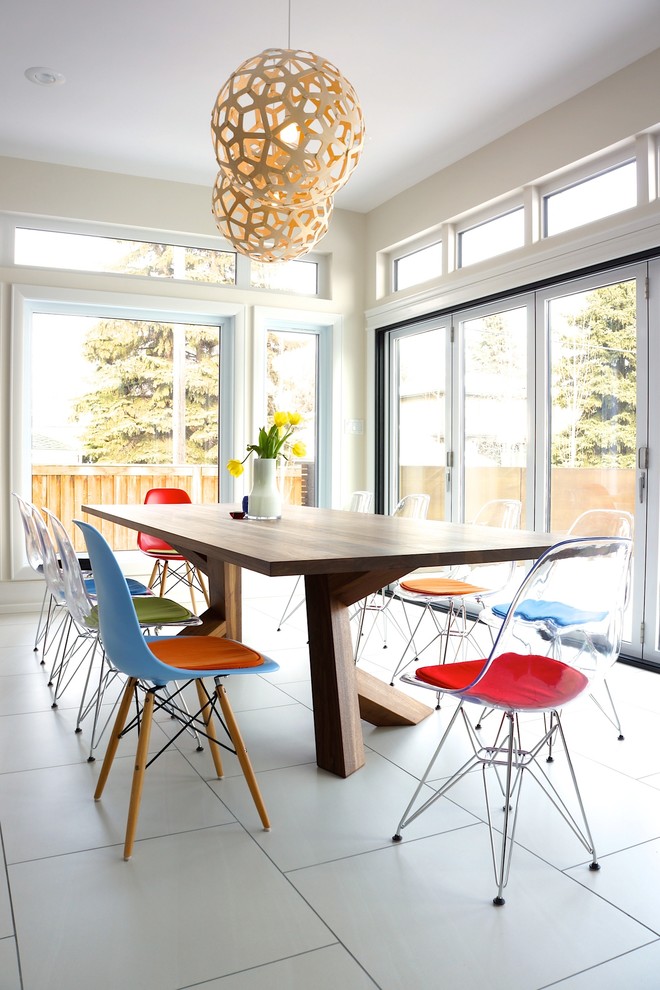 Photo of a small contemporary open plan dining in Edmonton with white walls and ceramic floors.