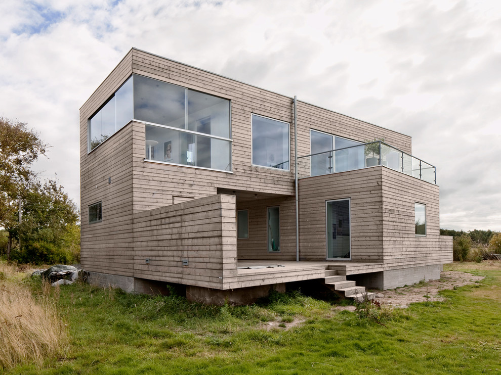 Idéer för att renovera ett stort industriellt beige trähus, med två våningar och platt tak