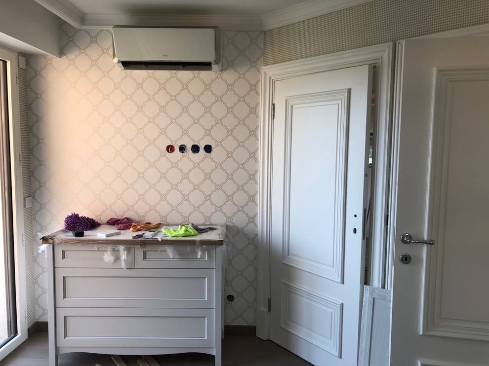 Photo of a small transitional kids' bedroom for kids 4-10 years old and girls in Other with beige walls, light hardwood floors and beige floor.