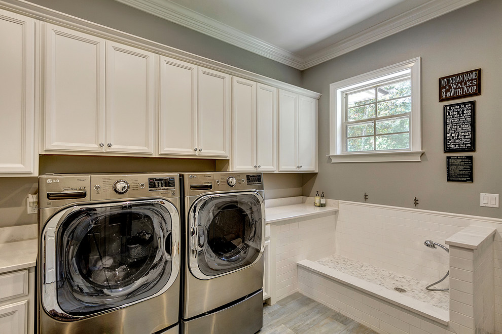 Design ideas for a traditional laundry room in Miami with recessed-panel cabinets, white cabinets, grey walls and a side-by-side washer and dryer.