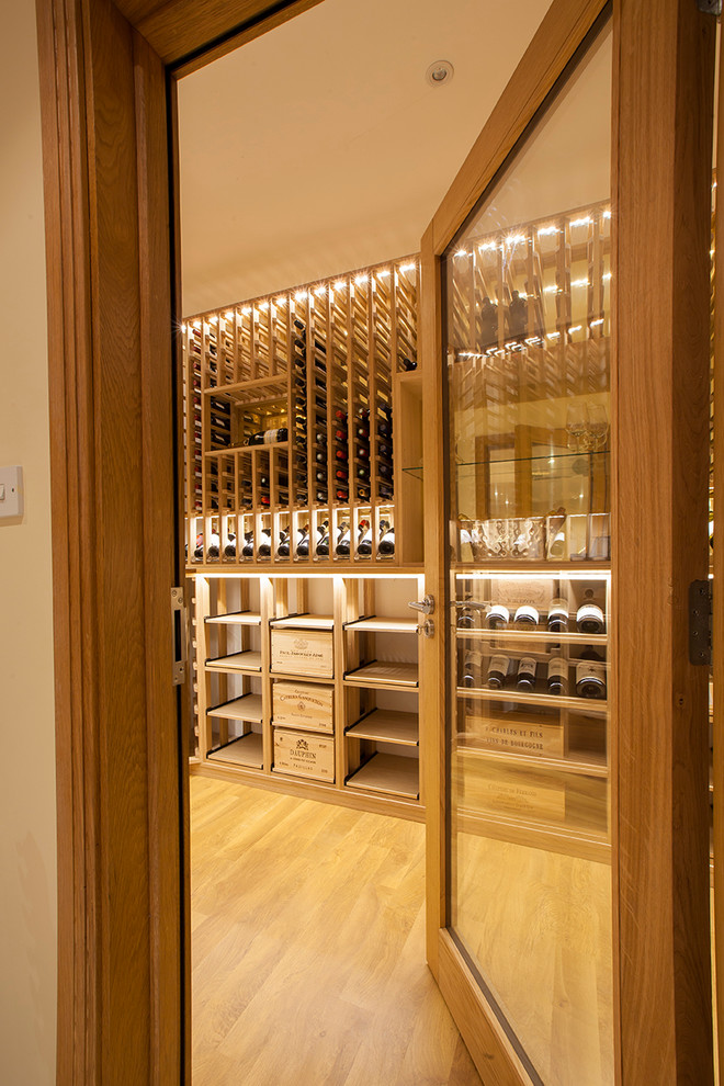 Design ideas for a contemporary wine cellar in Essex with storage racks.