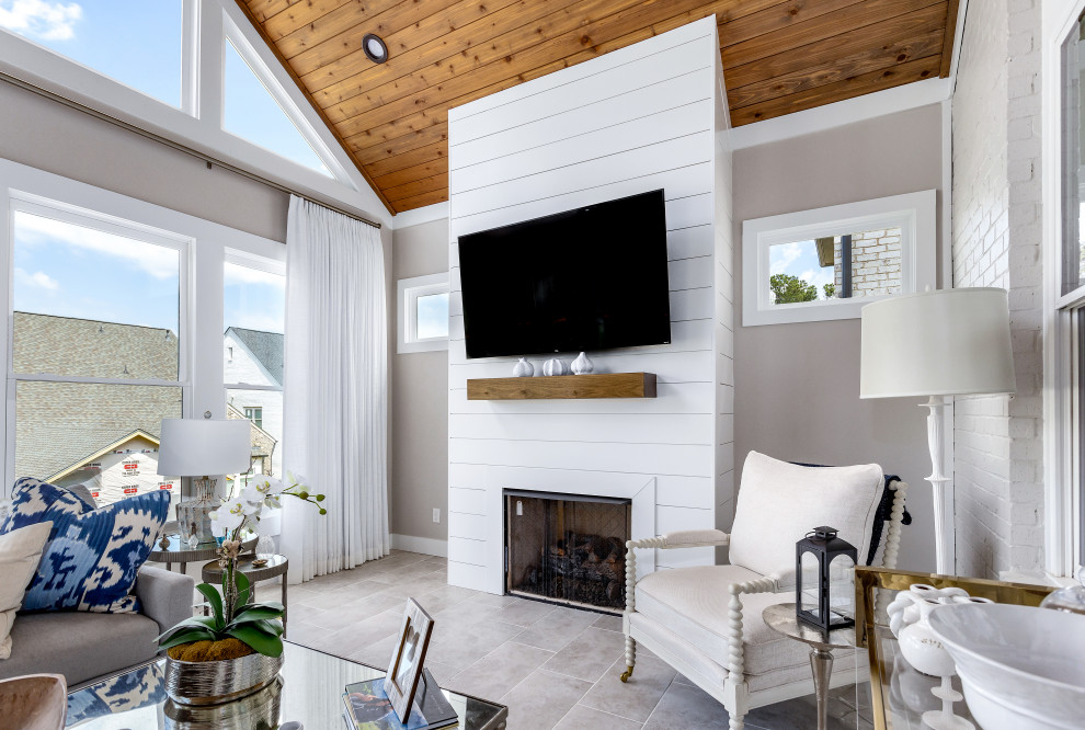 Example of a mid-sized transitional porcelain tile and gray floor sunroom design in Atlanta with a standard fireplace, a shiplap fireplace and a standard ceiling
