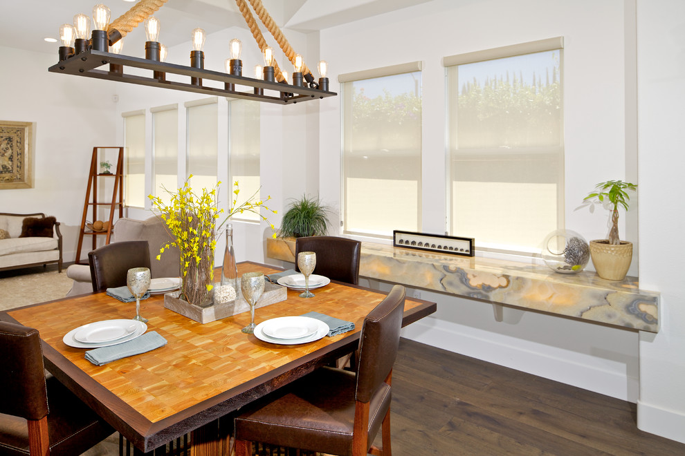 Inspiration for a traditional open plan dining in San Diego with white walls and dark hardwood floors.