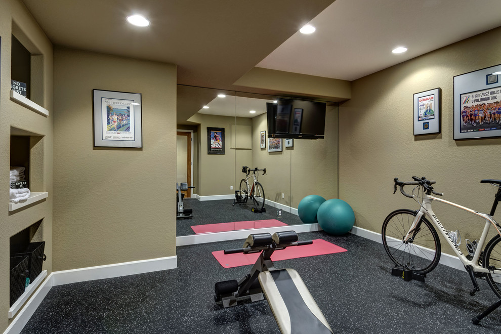 Large transitional multipurpose gym in Denver with beige walls and black floor.