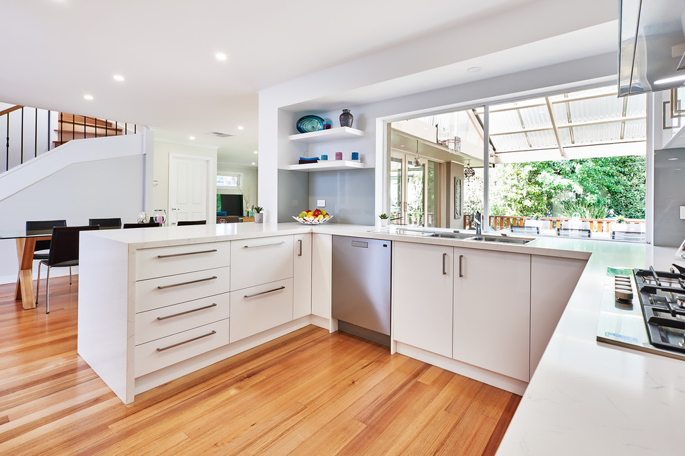Design ideas for a contemporary kitchen pantry in Melbourne with open cabinets, white cabinets and mirror splashback.
