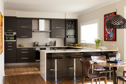 Eat-in kitchen - mid-sized transitional u-shaped medium tone wood floor and brown floor eat-in kitchen idea in DC Metro with an undermount sink, flat-panel cabinets, white backsplash, stainless steel appliances, a peninsula, dark wood cabinets, quartz countertops and glass tile backsplash