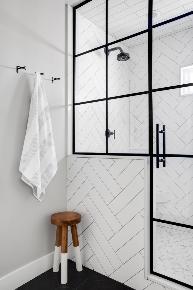 Example of a mid-sized trendy master white tile and subway tile porcelain tile, black floor and double-sink bathroom design in Orange County with flat-panel cabinets, light wood cabinets, gray walls, marble countertops, a hinged shower door, white countertops and a freestanding vanity