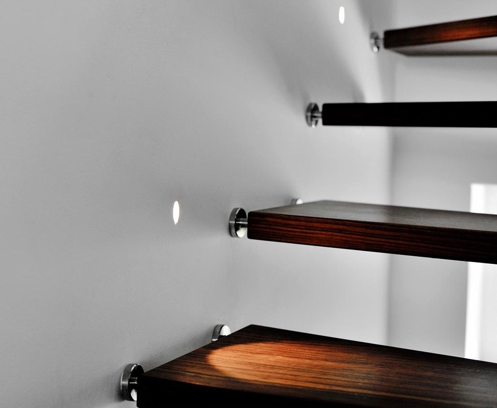 Photo of a mid-sized contemporary painted wood curved staircase in Munich with open risers.