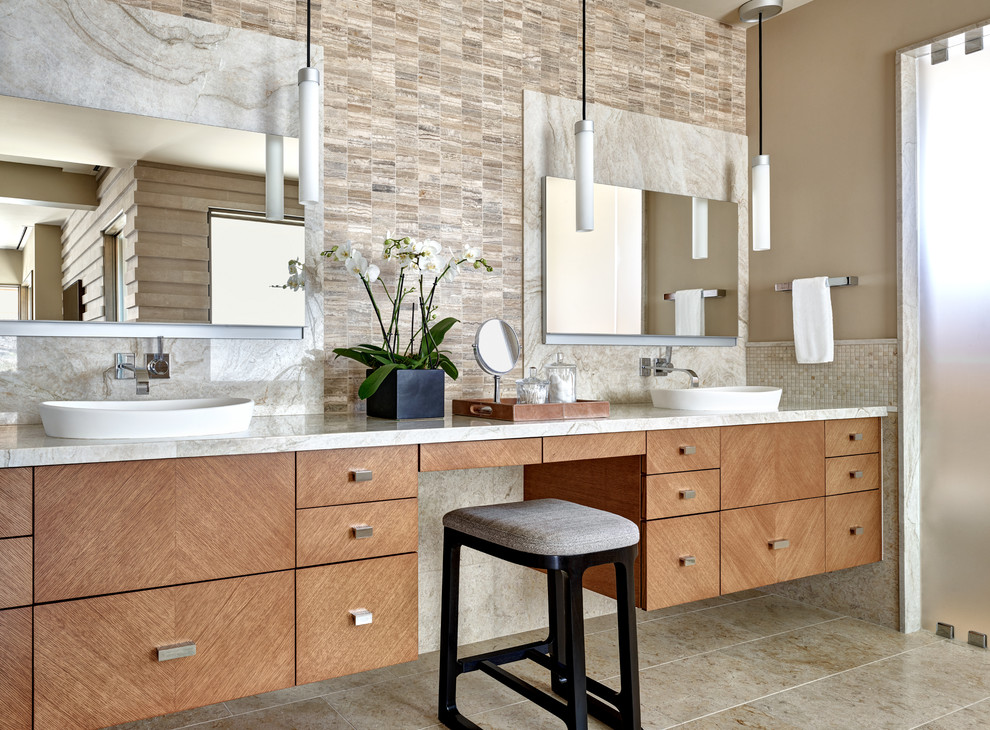 Inspiration for a large master bathroom in Phoenix with flat-panel cabinets, medium wood cabinets, stone tile, limestone floors, a vessel sink, quartzite benchtops, beige floor, white benchtops, beige tile and brown walls.
