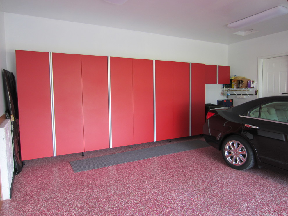 This is an example of a mid-sized traditional attached two-car garage in Other.