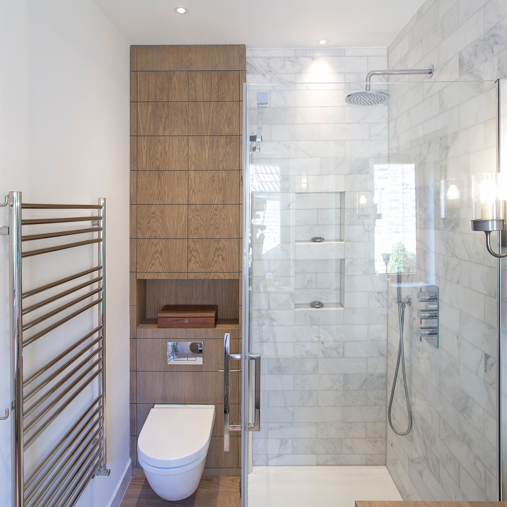 Inspiration for a small contemporary 3/4 bathroom in London with flat-panel cabinets, medium wood cabinets, a wall-mount toilet, white walls, a corner shower, brown tile and white tile.
