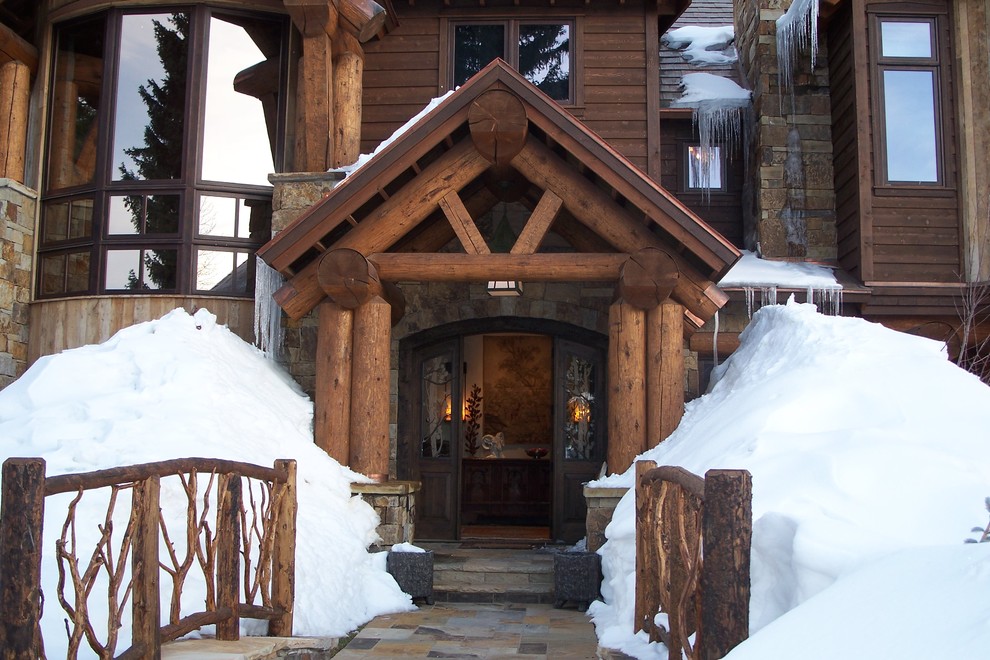 Inspiration for a traditional entryway in Other with a dark wood front door.