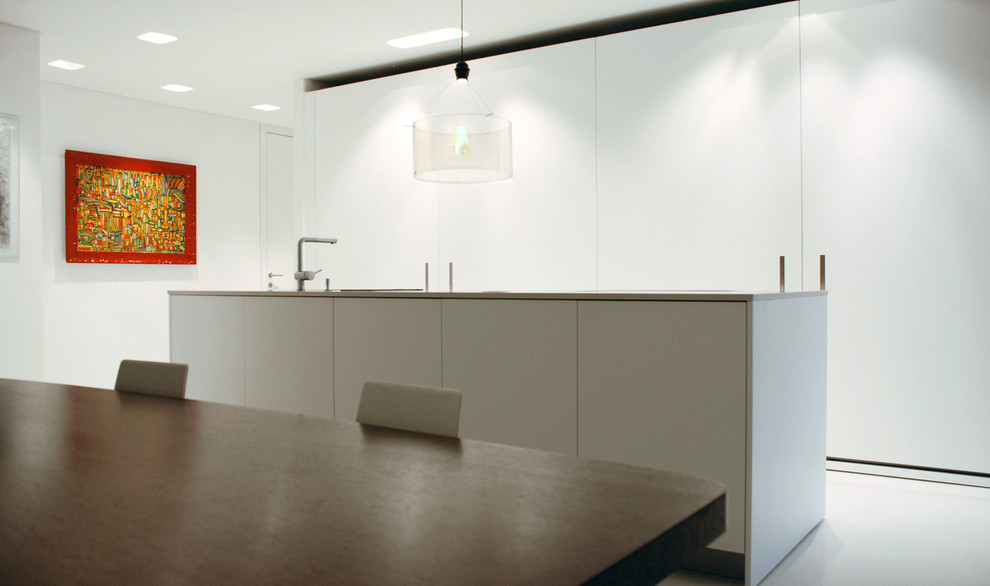 Photo of a contemporary kitchen in Other with flat-panel cabinets, white cabinets, with island and white splashback.