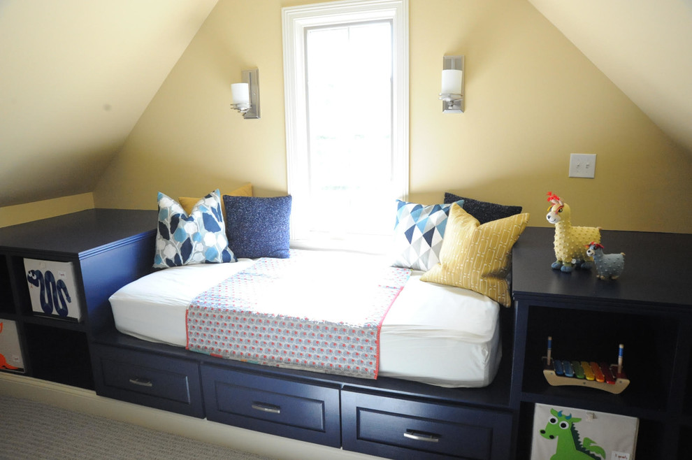 Photo of a large beach style gender-neutral kids' bedroom for kids 4-10 years old in Indianapolis with yellow walls and carpet.