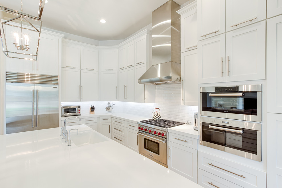 Example of a large transitional galley open concept kitchen design in Phoenix with shaker cabinets and an island