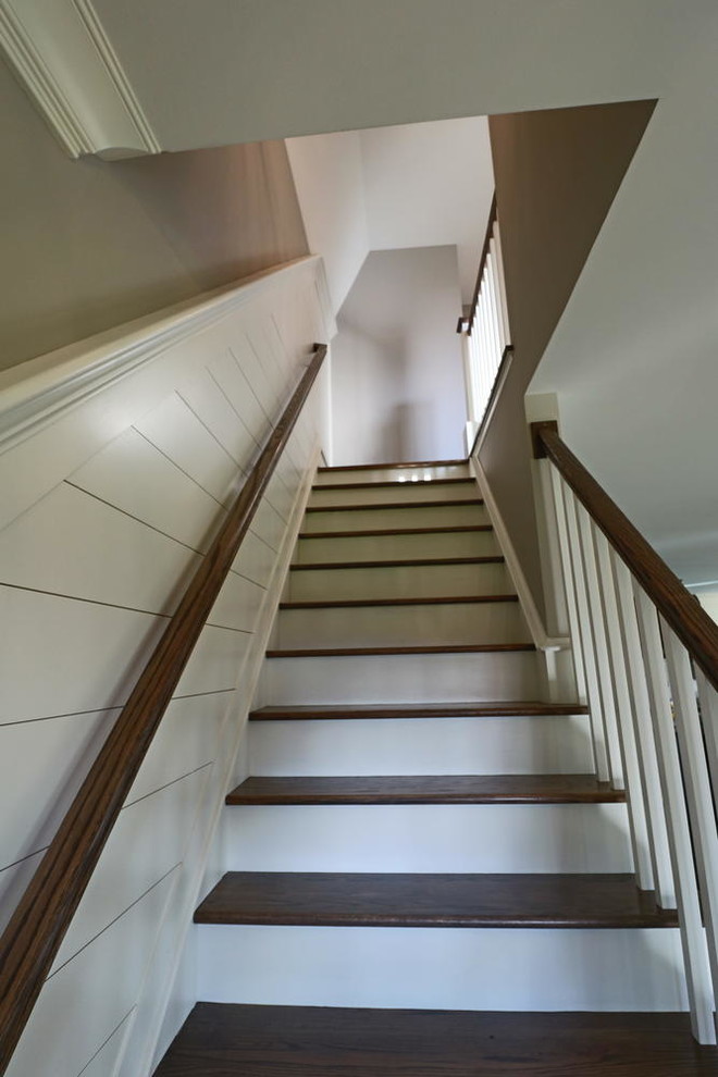Inspiration for a mid-sized country wood straight staircase in Boston with painted wood risers.