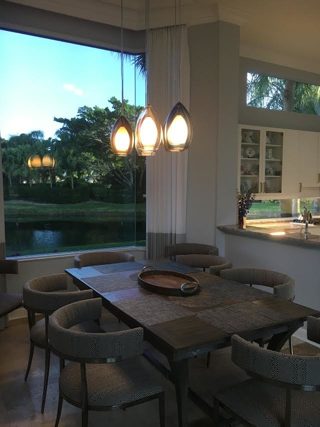 This is an example of a mid-sized contemporary kitchen/dining combo in Miami with grey walls, limestone floors and no fireplace.