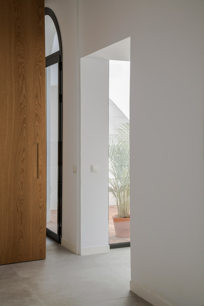 This is an example of a mid-sized mediterranean hallway in Barcelona with white walls.