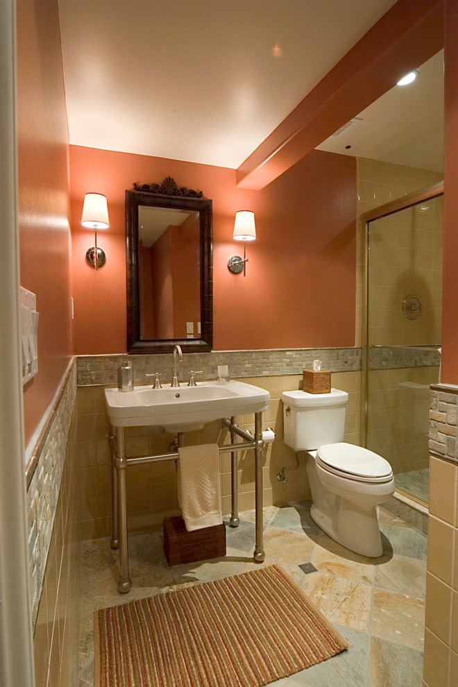 This is an example of a small traditional 3/4 bathroom in Denver with a pedestal sink, an alcove shower, a two-piece toilet, multi-coloured tile, ceramic tile, orange walls and slate floors.