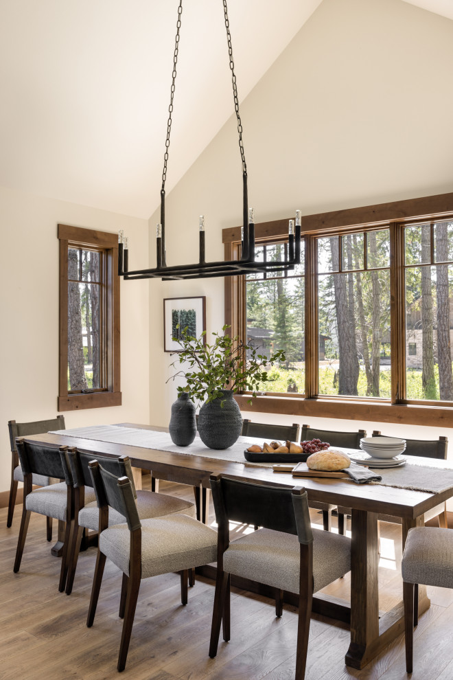 Design ideas for a medium sized modern enclosed dining room in Seattle with beige walls, medium hardwood flooring, no fireplace and a vaulted ceiling.