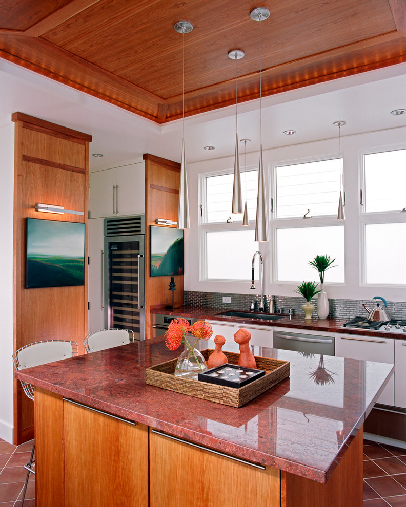 Photo of a traditional kitchen in San Francisco with flat-panel cabinets, medium wood cabinets, metallic splashback and red benchtop.