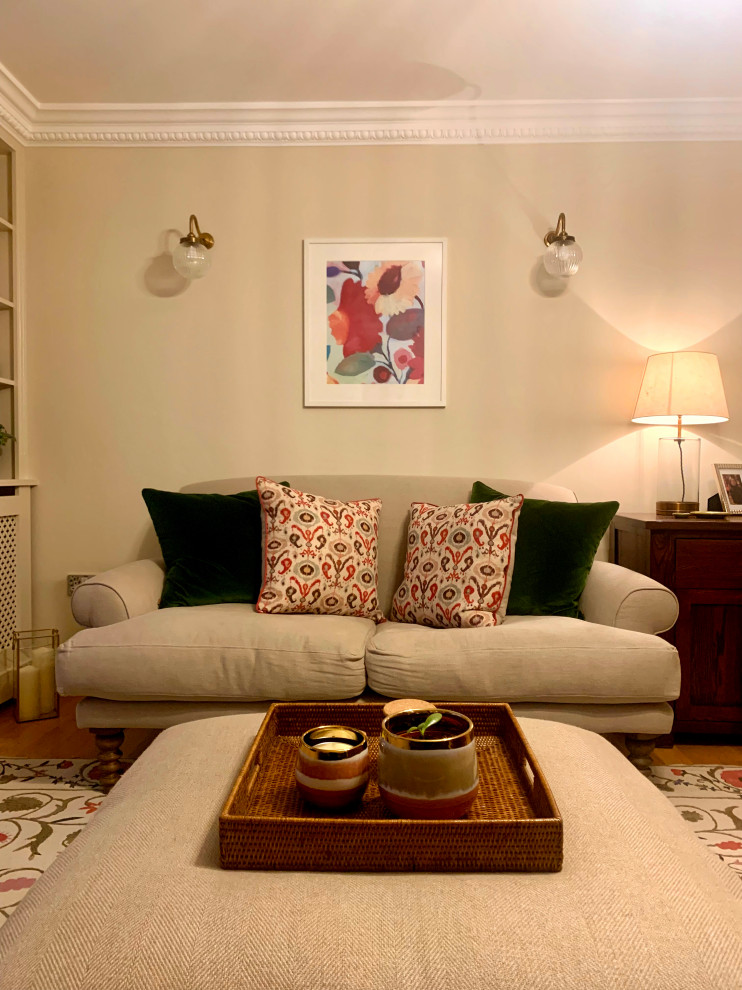 Medium sized traditional formal living room in London with medium hardwood flooring and brown floors.