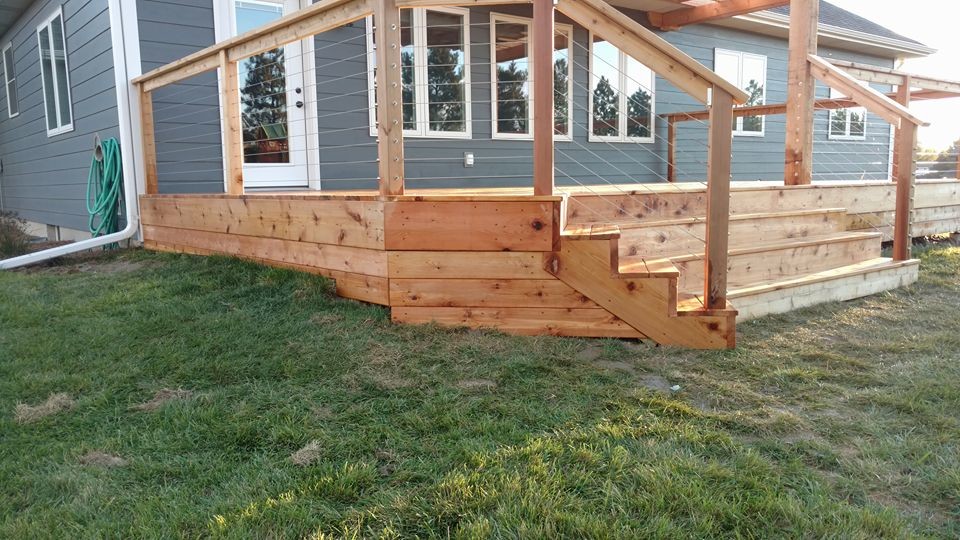 Example of a large mountain style deck design with a pergola