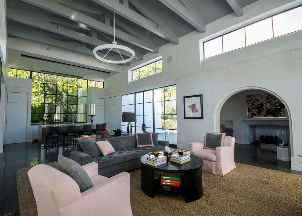 Design ideas for an expansive transitional loft-style family room in Los Angeles with a library, white walls, slate floors and a wall-mounted tv.