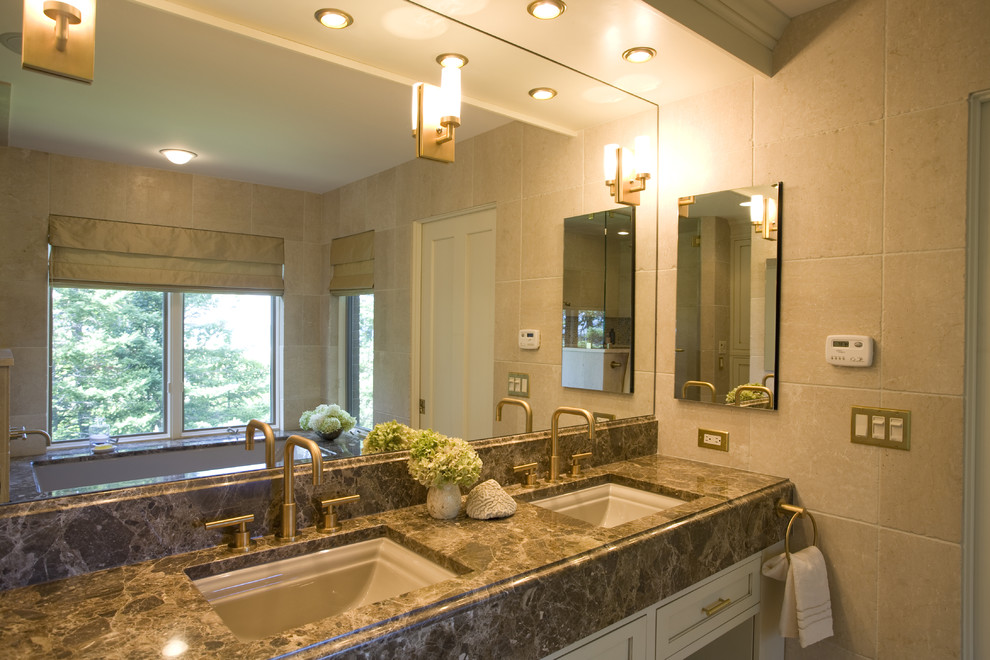 Photo of a traditional bathroom in Other with marble benchtops.