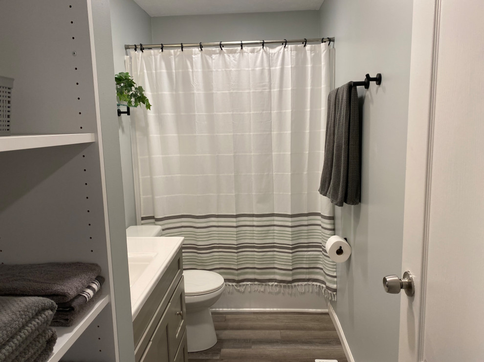 Large transitional l-shaped vinyl floor and gray floor open concept kitchen photo in Cincinnati with an undermount sink, raised-panel cabinets, white cabinets, granite countertops, multicolored backsplash, ceramic backsplash, stainless steel appliances, an island and black countertops