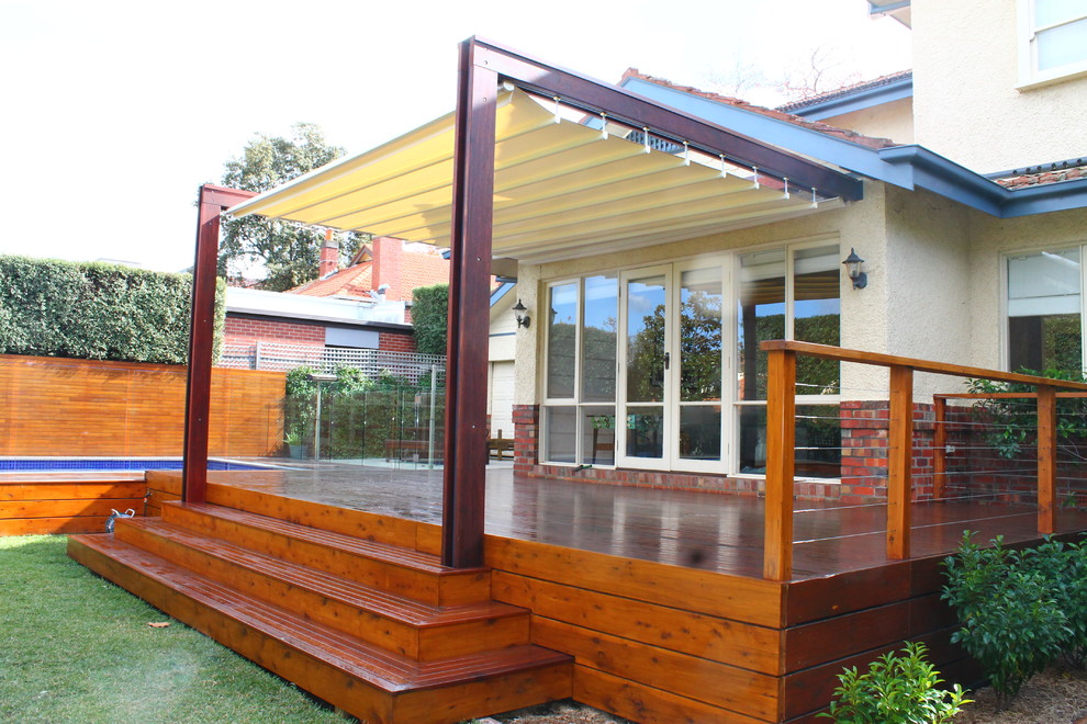 Large traditional backyard formal garden in Melbourne with decking.