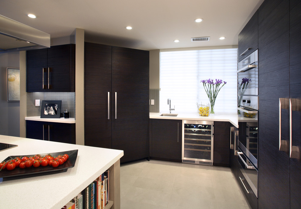 Photo of a large contemporary u-shaped separate kitchen in San Francisco with panelled appliances, a double-bowl sink, flat-panel cabinets, brown cabinets, quartz benchtops, grey splashback, glass sheet splashback, porcelain floors, with island and beige floor.