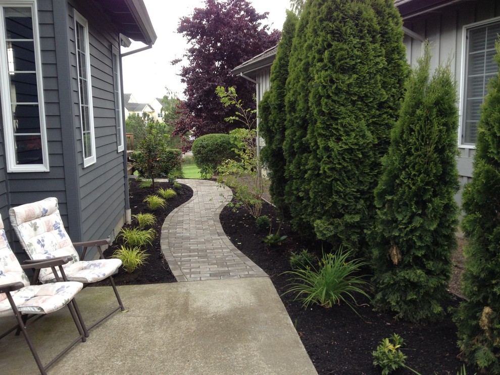 Small contemporary side yard partial sun formal garden in Portland with concrete pavers and a garden path for spring.