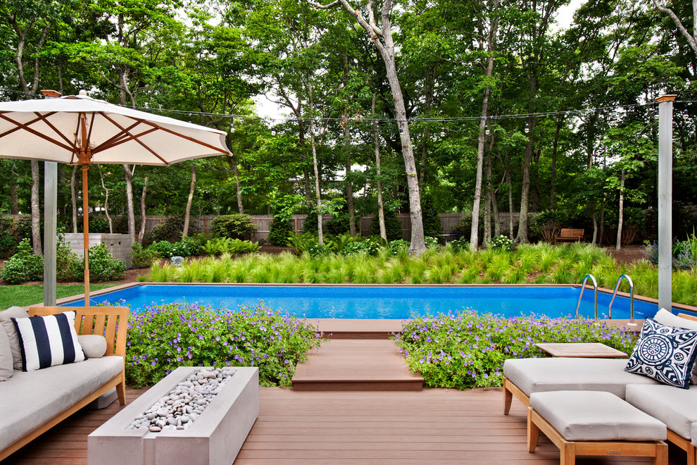 Inspiration for a transitional backyard rectangular lap pool in New York with decking.
