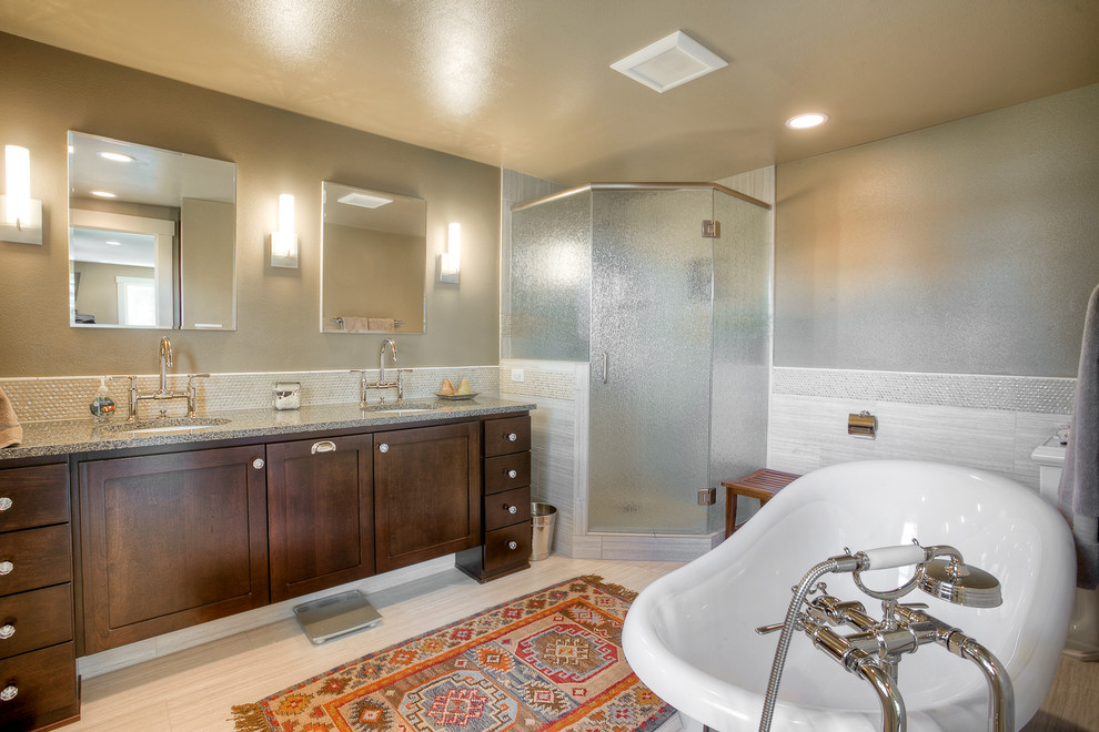 This is an example of a large master bathroom in Seattle with recessed-panel cabinets, dark wood cabinets, a freestanding tub, a corner shower, a one-piece toilet, beige tile, pebble tile, green walls, an undermount sink and quartzite benchtops.