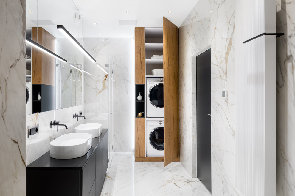 Inspiration for a large contemporary kids wet room bathroom in London with flat-panel cabinets, black cabinets, a freestanding tub, a wall-mount toilet, black and white tile, marble, multi-coloured walls, marble floors, a wall-mount sink, white floor, a hinged shower door, a double vanity, a floating vanity and wood walls.
